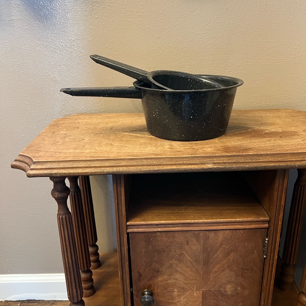 Pair of vintage black and white speckled enamelware sauce pans